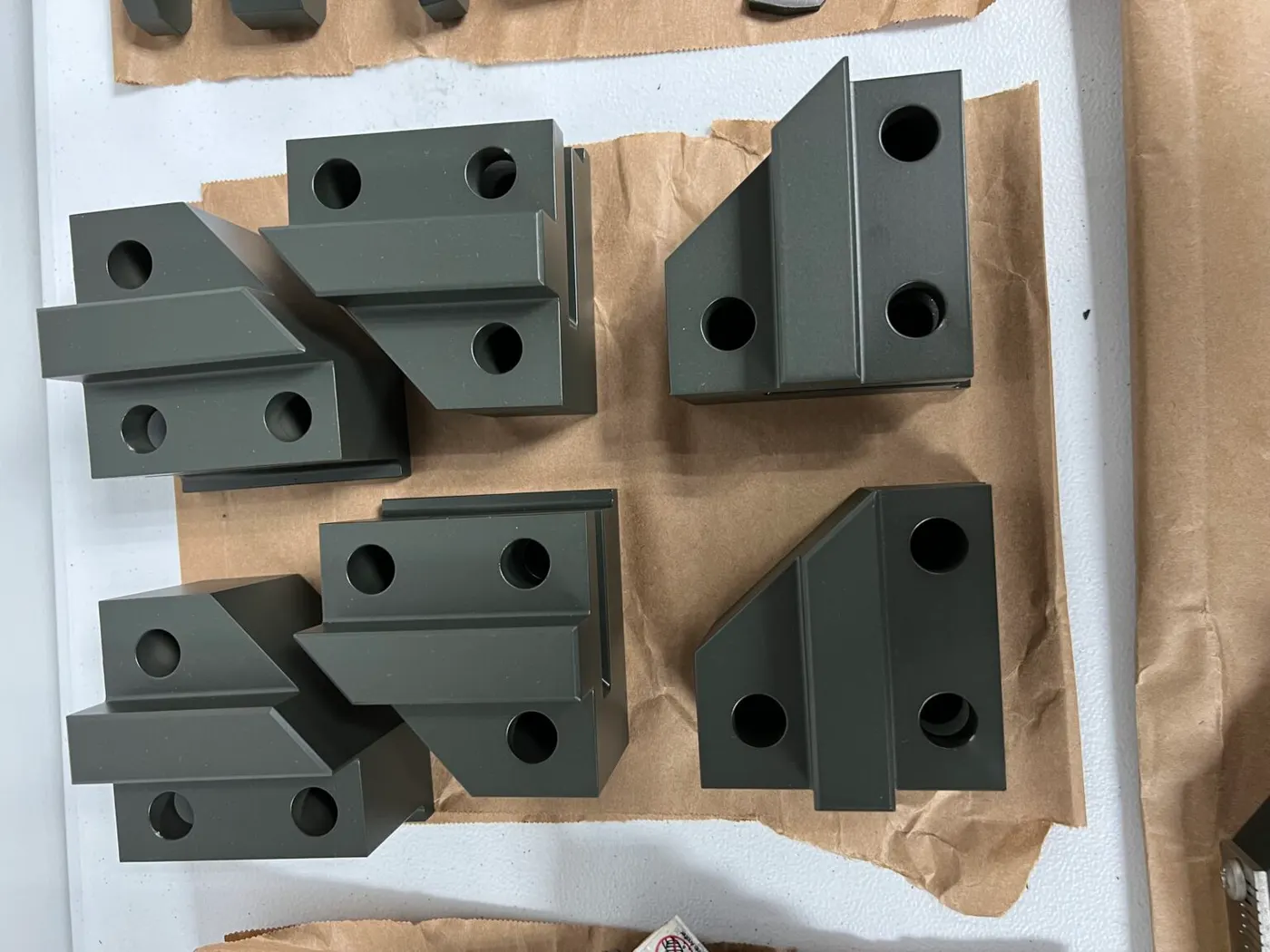 Finished, coated machined brackets.